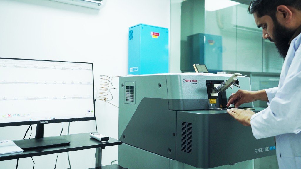 Technician in a white lab coat operating a SPECTRO AMETEK SPECTROMAXx metal analyzer in Chenab Engineering's in-house laboratory
