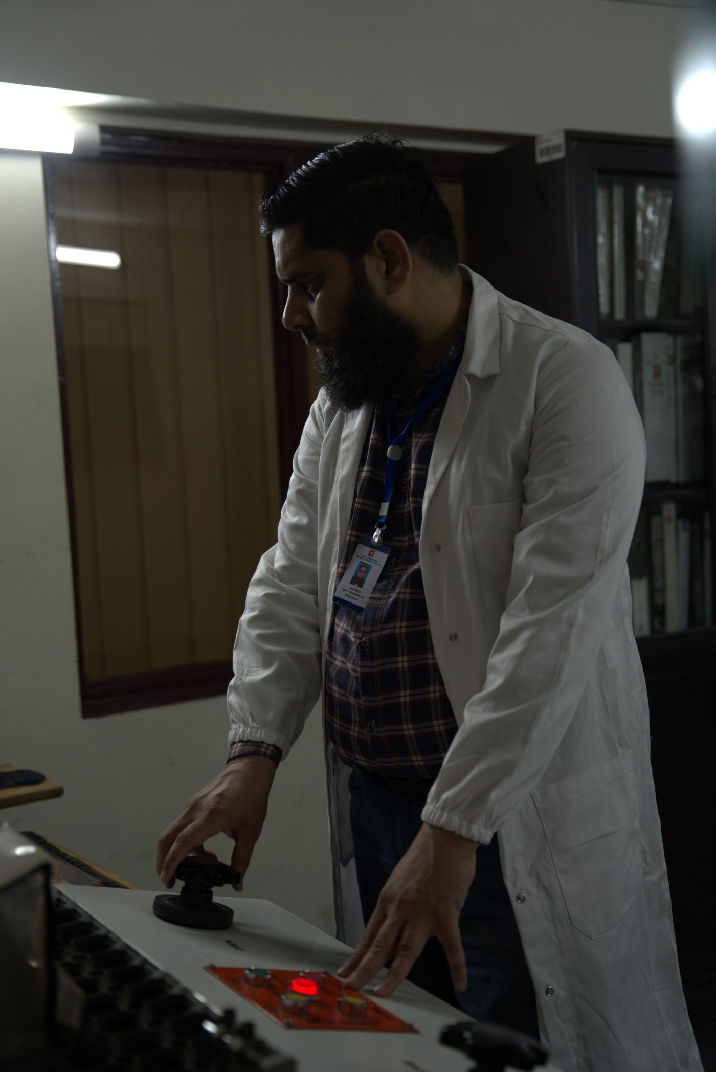 Metallurgist reviewing material grade selection on testing equipment